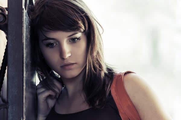 photo of a thoughtful woman who is suffering from substance use disorder