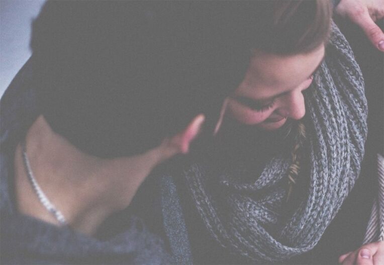 husband and wife hugging and talking to each other