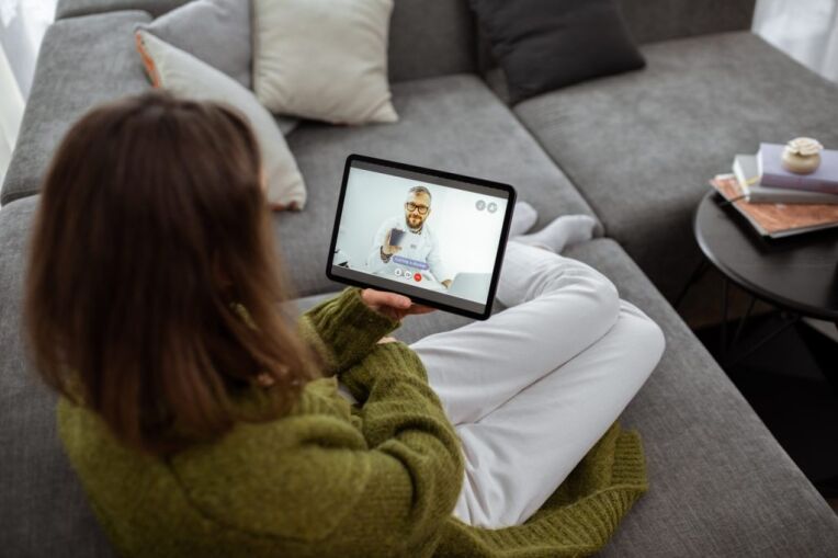 a woman talking to her doctor using tablet asking for prescription, telemedicine concept for Mental Health Treatment